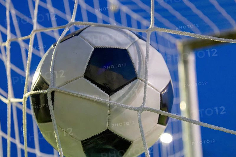 Soccer symbol: close-up of a soccer ball under floodlights