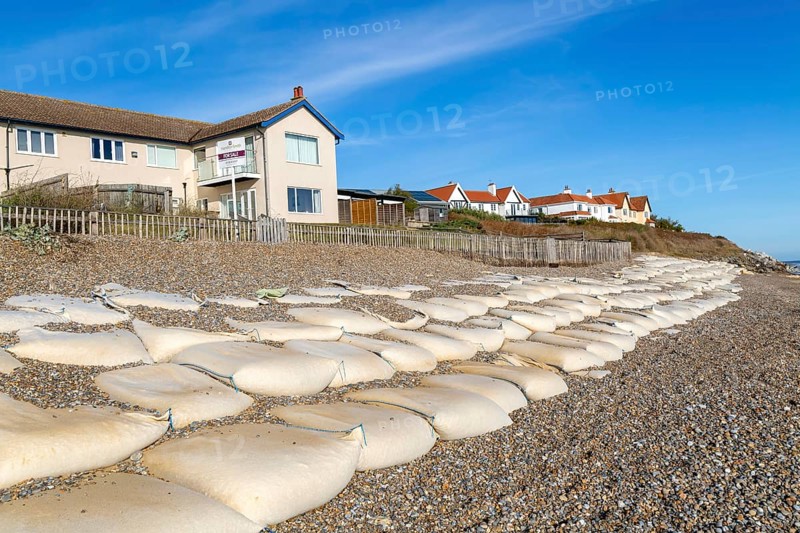 For Sale estate agent signs outside houses at risk of coastal erosion, Thorpeness, Suffolk, North Sea coast, England, UK October 2025