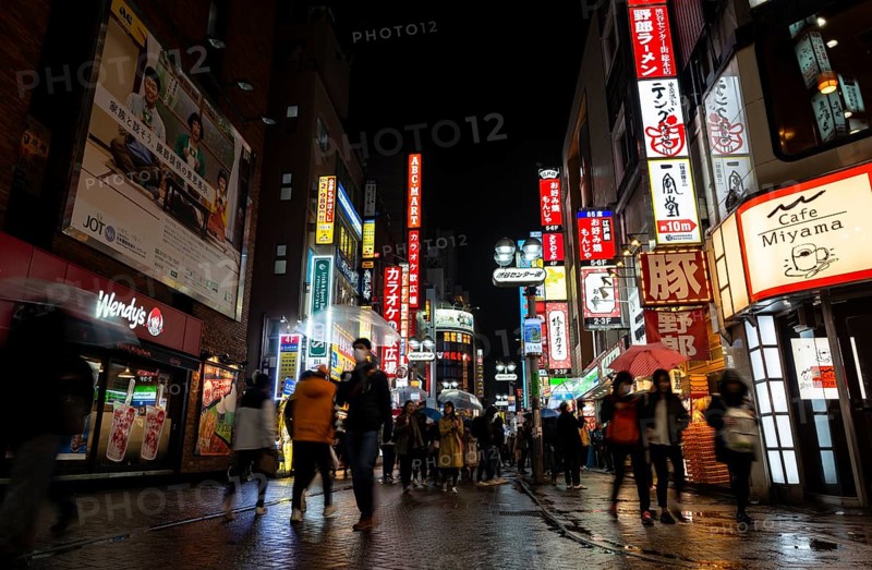 Busy pedestrian zone with many shopping centers and stores, illuminated with lots of neon signs at night, Shibuya, Udagawacho, Tokyo, Japan