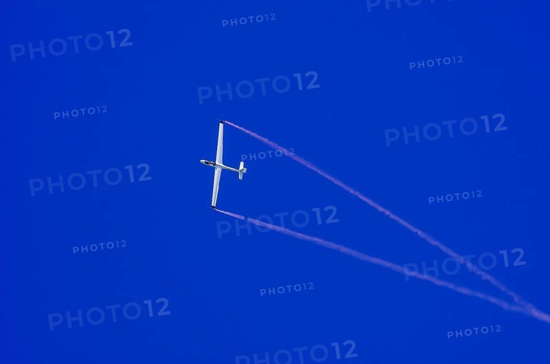 An SZD-59-1 ACRO glider, registration D-1138, during a demonstration as part of an air show at the Fliegerbergfest of the Rossfeld Luftsportverein in Metzingen-Glems, Baden-Württemberg, Germany, for editorial use only
