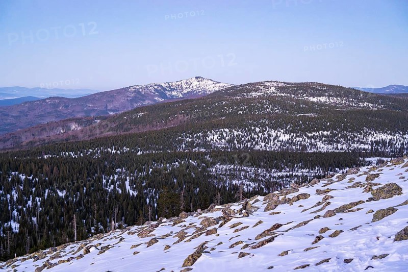 View from Mount Lusen over the hills of the bavarian forest at sunrise in winter, Bavaria, Germany