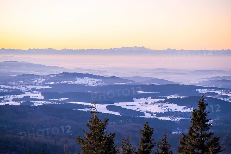 View from Mount Lusen over the hills of the bavarian forest at sunrise in winter, Bavaria, Germany