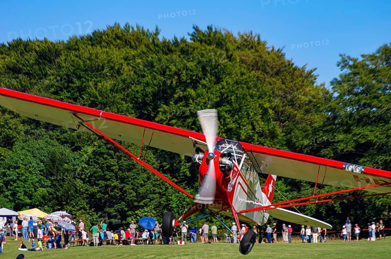 A Piper J-3C/L4 Cub light aircraft, HB-OBF registration, during a flight demonstration as part of an air show on Rossfeld in Metzingen-Glems, Baden-Württemberg, Germany, for editorial use only