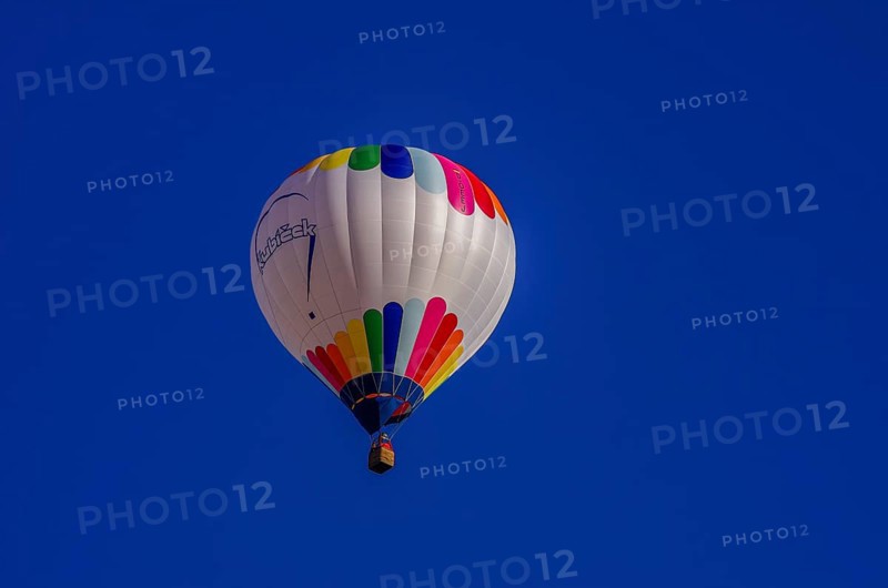A hot air balloon, registration D-OÖJ, rises into the air as part of an air show at the Fliegerbergfest of the Rossfeld Luftsportverein in Metzingen-Glems, Baden-Württemberg, Germany, for editorial use only