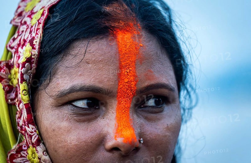 A Hindu devotee offer prayers to the Sun God on the bank of Brahmaputra river on the occasion of Chhath Puja, in Guwahati, India on 27 October 2025