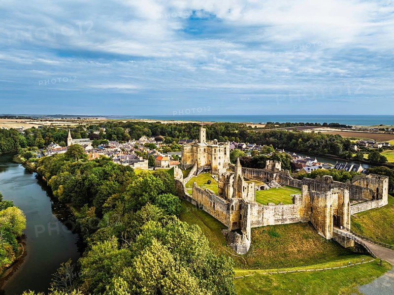 Warkworth Castle over River Coquet from a drone, Warkworth, Northumberland, England, United Kingdom