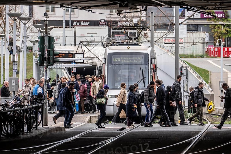 Pedestrians cross the tram tracks, at Düsseldorf-Bilk station, junction of S-Bahn, subway, tram, local bus transport, North Rhine-Westphalia