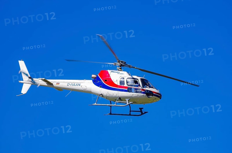 An Aerospatiale AS-350 BA Ecureuil helicopter, registration D-HAAN, from Meravo Air Company during a flight demonstration as part of an air show on Rossfeld in Metzingen-Glems, Baden-Württemberg, Germany, for editorial use only