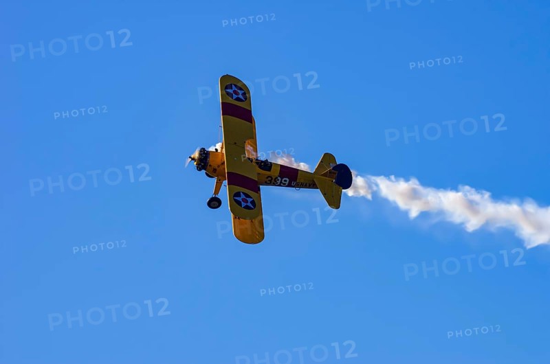 A Boeing PT-17 Stearman biplane, also Boeing Stearman Model 75, with the inscription 399 USNAVY N67193 during a flight demonstration as part of an air show on Rossfeld in Metzingen-Glems, Baden-Württemberg, Germany, for editorial use only