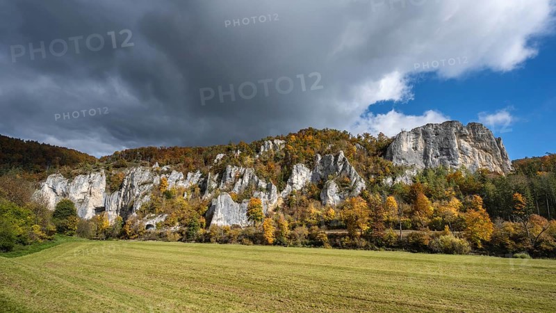 Distinctive Jurassic limestone cliffs in the upper Danube Valley, surrounded by autumn vegetation, on the right the raven rocks, Sigmaringen district, Baden-Württemberg, Germany