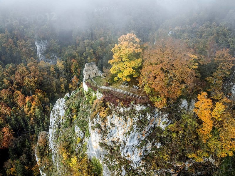 Aerial view of the viewpoint, shovels and Hausen Castle, also known as the Hausen ruins, surrounded by autumnal vegetation and clouds of fog, a ruin of a castle above the village of Hausen in the valley in the Upper Danube Valley, Beuron, Sigmaringen district, Baden-Württemberg, Germany
