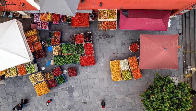 Traditional Mexican plaza with crates of peppers, onions, and tomatoes, economic prosperity in local trade, travel destination in America, AI generated