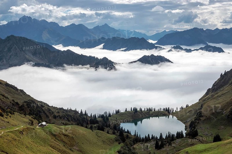 View of Seealpsee and Allgäu Alps, mountains rising from fog in the valley, Nebelhorn, Oberstdorf, Oberallgäu, Allgäu, Bavaria, Germany