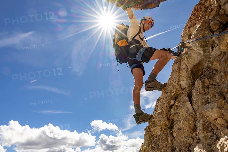 Mountaineer climbs on Ferrata Furcela de Saslonch, Langkofelscharte via ferrata, Dolomites, Trentino, South Tyrol, Italy