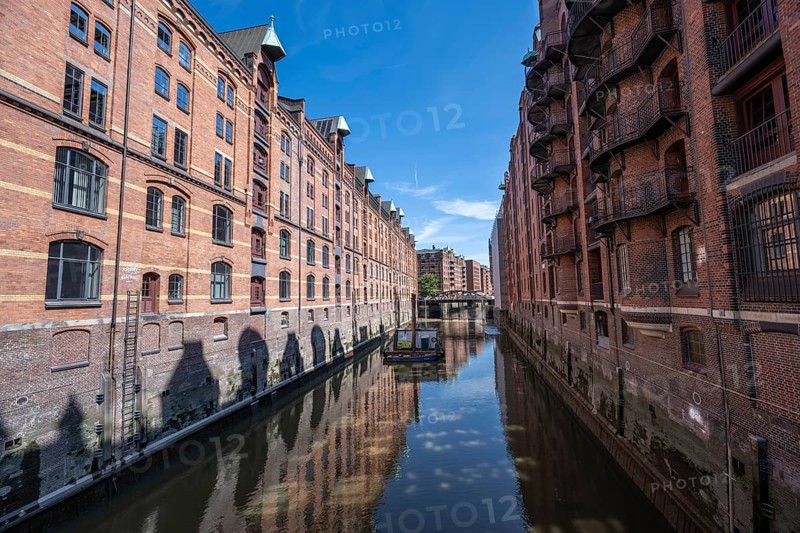 Canal between red brick buildings, warehouses in Hamburg's Speicherstadt, Hamburg, Germany