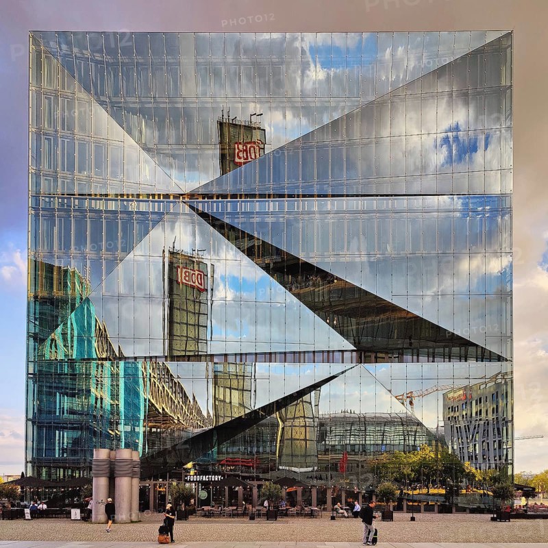 Cube Berlin, cube-shaped office building with inwardly folded glass façade reflecting the surroundings, Washingtonplatz, Berlin, Germany