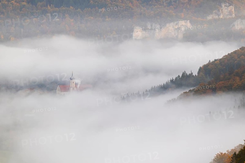 View of Benedictine monastery Beuron, Archabbey of St. Martin, limestone rock, rock face, mixed forest, autumn colours, fog, autumn, Fridingen, Danube Valley, Upper Danube nature park Park, Baden-Württemberg, Germany