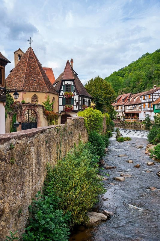 Picturesque Kaysersberg with half-timbered houses on the Weiss river in the old town centre