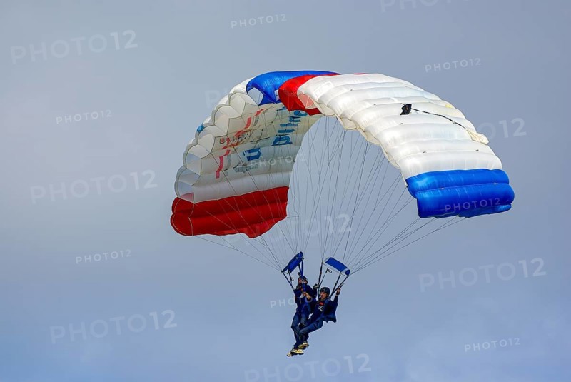 Two parachutists during an aerial acrobatic performance as part of an air show at the Rossfeld in Metzingen-Glems, Baden-Württemberg, Germany, for editorial use only