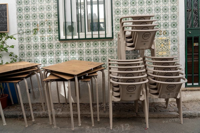 Restaurant furniture, for outdoor catering, tables, chairs, stacked, day off, catering closed, old town of Tavira, Algarve, Portugal