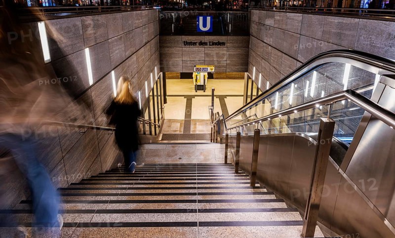 Night photo, long exposure with motion blur, modern underground entrance at Unter den Linden station, contemporary design with stairs and escalator, Berlin, Germany