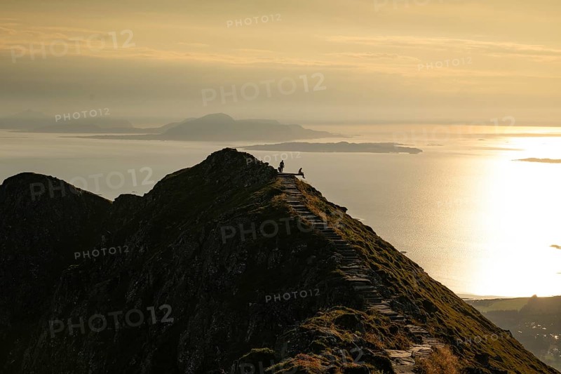 Hikers on the Rørsethornet stone staircase, with 3292 steps one of the longest continuous stone staircases in the world, Sherpatreppe or Midsundtreppe or Midsundtrappene, Rørsethornet hike, evening mood, Otroya or Otrøya island, Møre og Romsdal, Norway