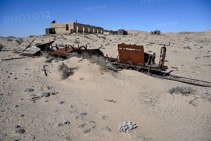 Wagon of an old narrow-gauge railway in the desert sand, Pomona, restricted diamond area, near Lüderitz, Karas region, Namibia