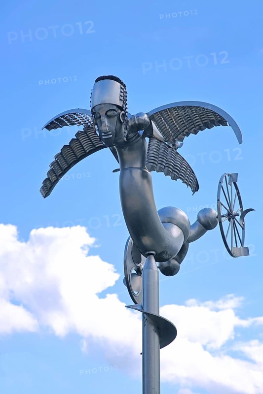 Sculpture Birdman by Albert Sous, modern art, abstract art, stainless steel, metal sculpture, whimsical bizarre bird figure, mythical creature, hybrid creature, wings, flying, wheel, cut-out, detail, Bastinsweiher, Rhineland, Stolberg, North Rhine-Westphalia, Germany