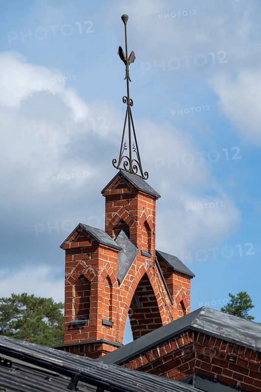 Iron ornamental element on roof peak, brick gable, former paper mill for the production of groundwood pulp board, UNESCO World Heritage Site Factory Village Verla, Maailmanperintökohde Verlan puuhiomo ja pahvitehdas, Verla Rapids, Kymenlaakso, near Kouvola, Finland