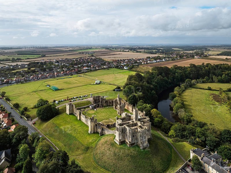Warkworth Castle over River Coquet from a drone, Warkworth, Northumberland, England, United Kingdom