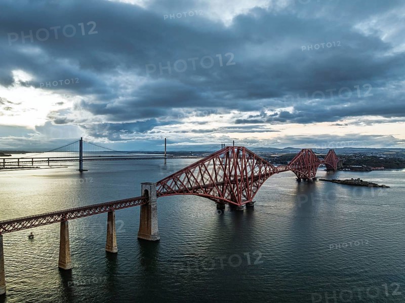 Rain clouds over Forth Bridge from a drone, Queensferry Crossing, Forth Estuary, Scotland, United Kingdom
