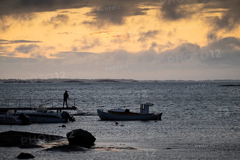 Small bay, archipelago, jetty with angler, Resö Island, Bohuslän, Skagerrak, Sotenäs, Västra Götalands län, Sweden