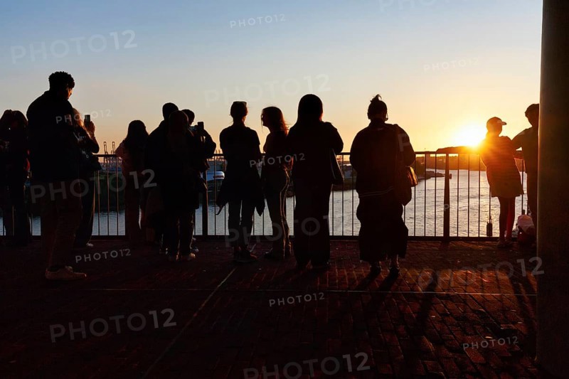 Crowd enjoying the view from the Elbphilharmonie over the Elbe at sunset, silhouettes, Plaza viewing platform, Hamburg, Germany