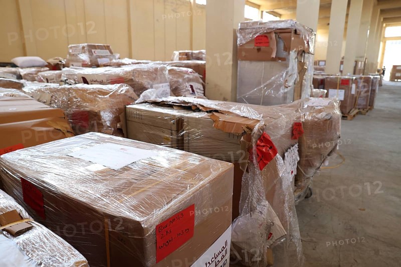 Relief workers unload boxes of medical aid provided by Qatar at Damascus International Airport, part of the humanitarian bridge supporting Syria's recovery and reconstruction after the fall of Bashar al-Assad, Damascus, Damascus, Syria