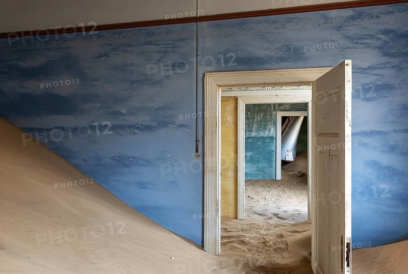 At Kolmanskop, the abandoned ghost town of the diamond days of the early 1900 and of German origin. Inside the restricted Diamond Area east of the coastal town of Lüderitz. Namib Desert, Namibia