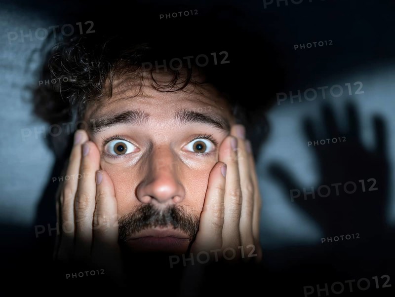A close-up of a man whose face is marked by fear, symbolising anxiety disorders, panic attacks, mental illness, AI generated, AI generated