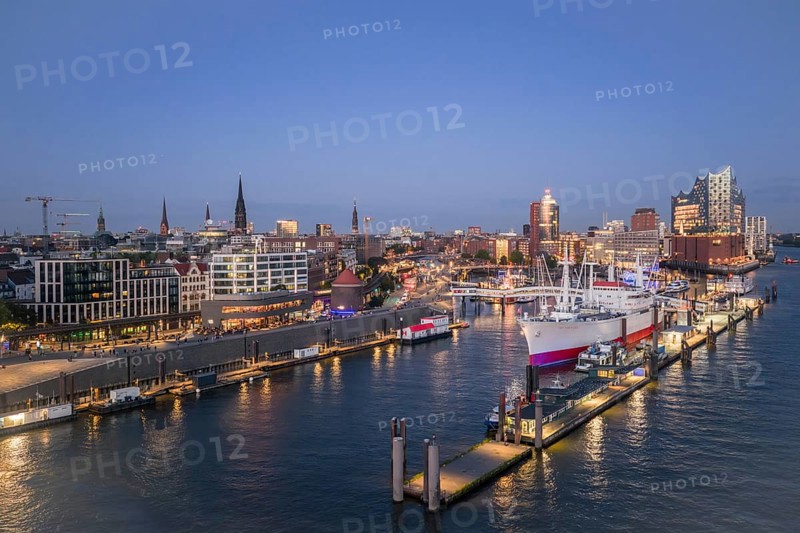 Aerial view of the Landungsbrücken Hamburg (Jan-Fedder-Promenade) at blue hour with Elbe, Cap San Diego and Elbphilharmonie in the background, Hamburg, Germany
