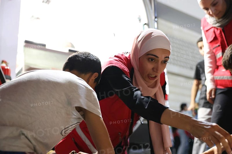 Syrian Arab Red Crescent volunteers conduct first aid training for children during the Damascus International Fair, the first edition held after the fall of Bashar al-Assad. The activity raises awareness of health, safety, and emergency preparedness among young visitors, Damascus, Damascus, Syria