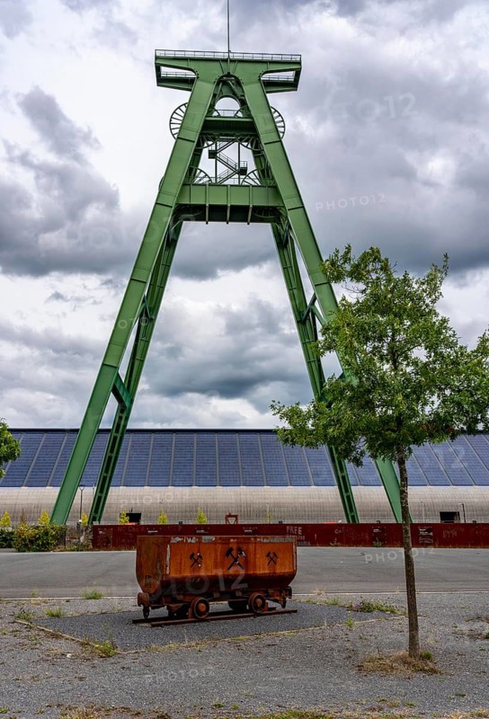 The former Lohberg coal mine in Dinslaken, today a leisure, work and residential quarter, Kreativquartier Lohberg, pithead frame of shaft 2, behind the coal mixing hall with 11500 square metre solar roof, output of 1, 813 KW peak power, freshly renovated, North Rhine-Westphalia, Germany