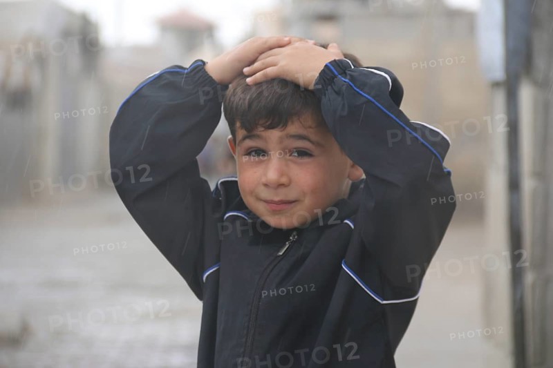 A Syrian refugee child photographed in a camp, reflecting the harsh living conditions of displaced families. Aleppo, Syria March 2, 2017, Aleppo, Syria