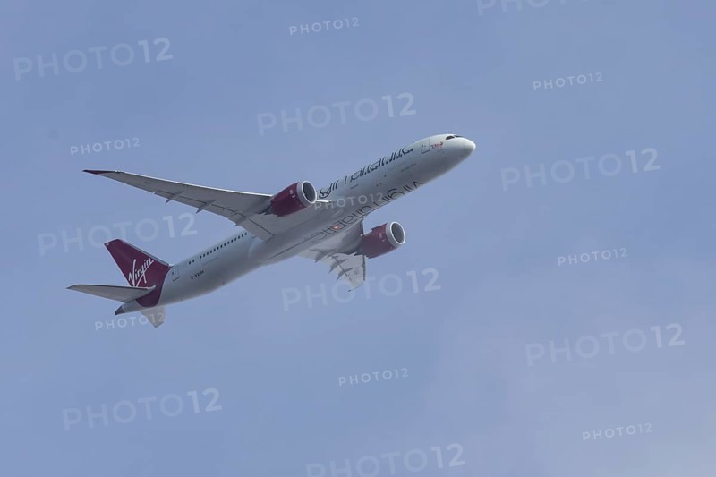 Boeing 787 Dreamliner jet passenger aircraft of Virgin Atlantic airlines in flight in a blue sky, England, United Kingdom