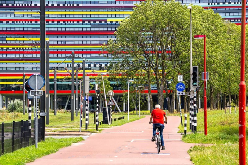 Cycle path through the university campus in Utrecht Science Park, Utrecht University, colourful facade of the Hogeschool Utrecht building, Netherlands
