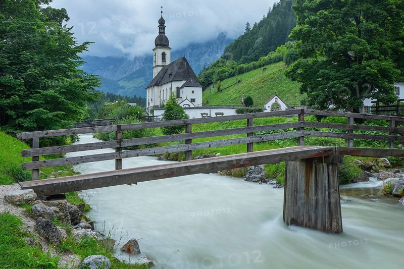 St Sebastian in Ramsau in Berchtesgadener Land with rain clouds after heavy rain