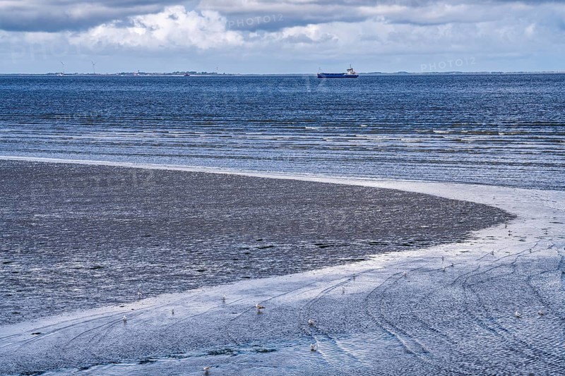 Wadden Sea between the Dutch coast near Eemshaven and the German North Sea island of Borkum, Wadden Sea National Park, UNESCO World Heritage Site, low tide, low water, clouds