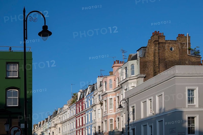 Terraced houses, townhouses with different, colourfully painted facades under a blue sky, Portobello Road, Notting Hill, London, England, Great Britain
