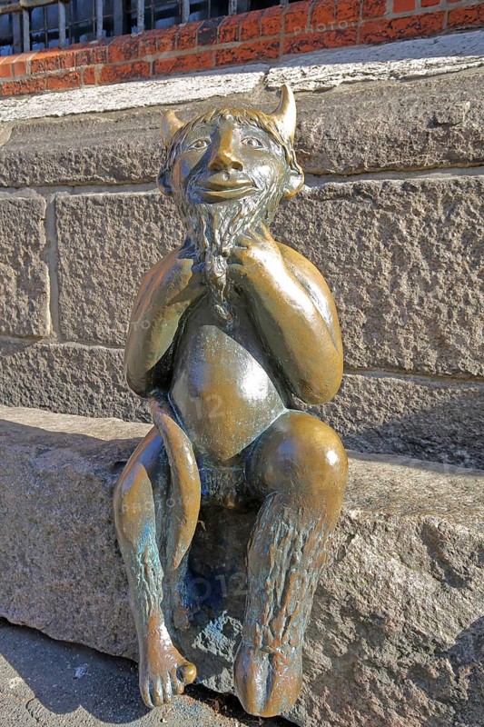 Sculpture Devil by Rolf Goerler 1999 sitting on the Devil's Stone, bronze sculpture, modern art, St. Mary's Church, Old Town, Lübeck, Schleswig-Holstein, Germany