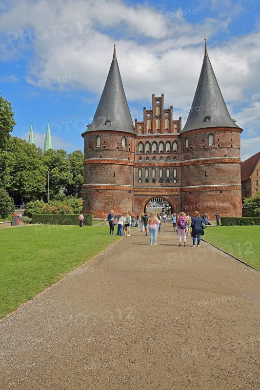 Historic Holsten Gate and pedestrians, tourists, Brick Gothic, brick building, city gate, landmark, Holsten Gate Square, Old Town, Lübeck, Schleswig-Holstein, Germany