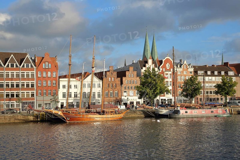 Ships on the banks of the Stadttrave, houses, cityscape, sailing ship, harbour, steeples of St. Mary's Church, light mood, old town, Lübeck, Schleswig-Holstein, Germany