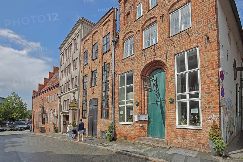 Restaurant Nachtschwärmer with nose sign, pedestrian, brick building, houses, Alfstraße, Old Town, Lübeck, Schleswig-Holstein, Germany
