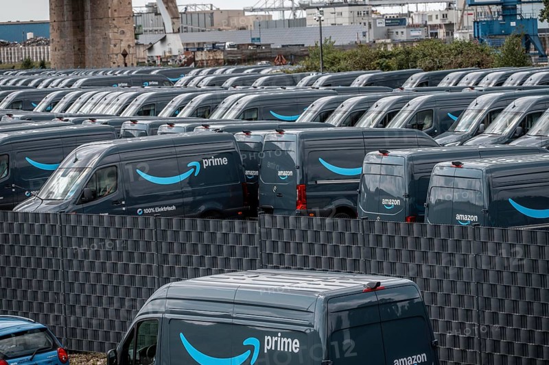 New delivery vehicles for the online mail order company Amazon Prime, with electric drive, are waiting for delivery in the inland port of Duisburg, Duisport, North Rhine-Westphalia, Germany